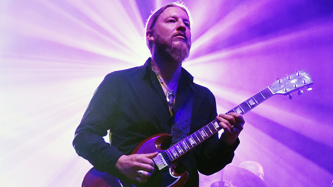 a shot of derek trucks on stage