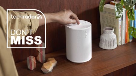 The Sonos Era 100 speaker on a counter top with a President's Day deal sticker 