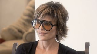 Rinna wearing sunglasses and talking to Erika in the Season 12 premiere of RHOBH