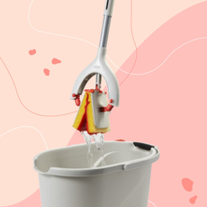 The oxo butterfly mop and angeled bucket on pink background