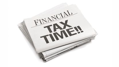 Stack of financial newspapers with the headline 'Tax Time!!'