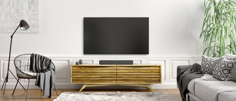 the denon home sound bar 550 underneath a tv