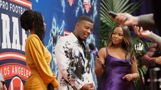 Karimah Westbrook as Grace James and Daniel Ezra as Spencer James on the red carpet for the NFL Draft in All American season 6 episode 12