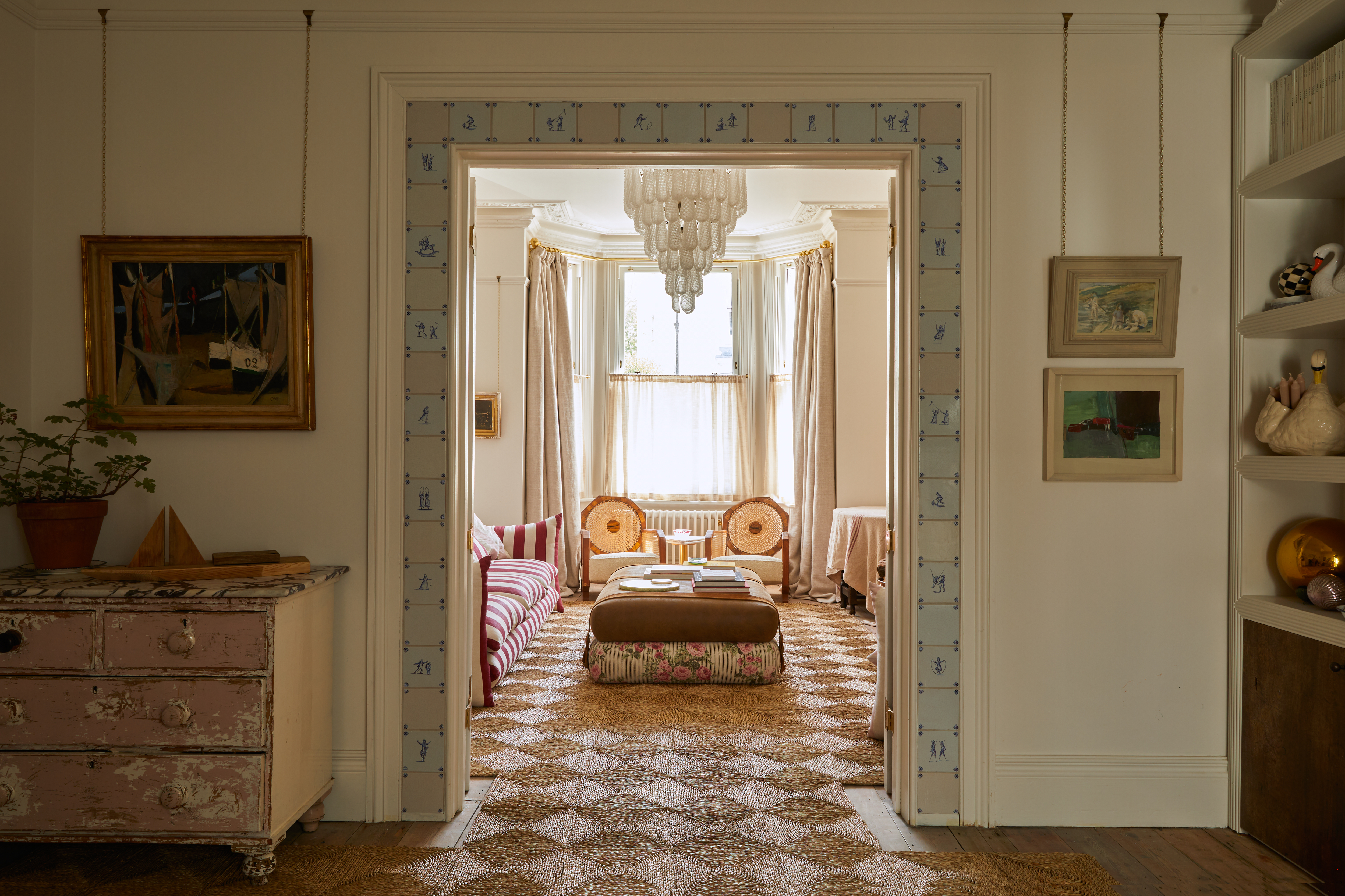 a view through a door into a living room surrounded by patterned tiles