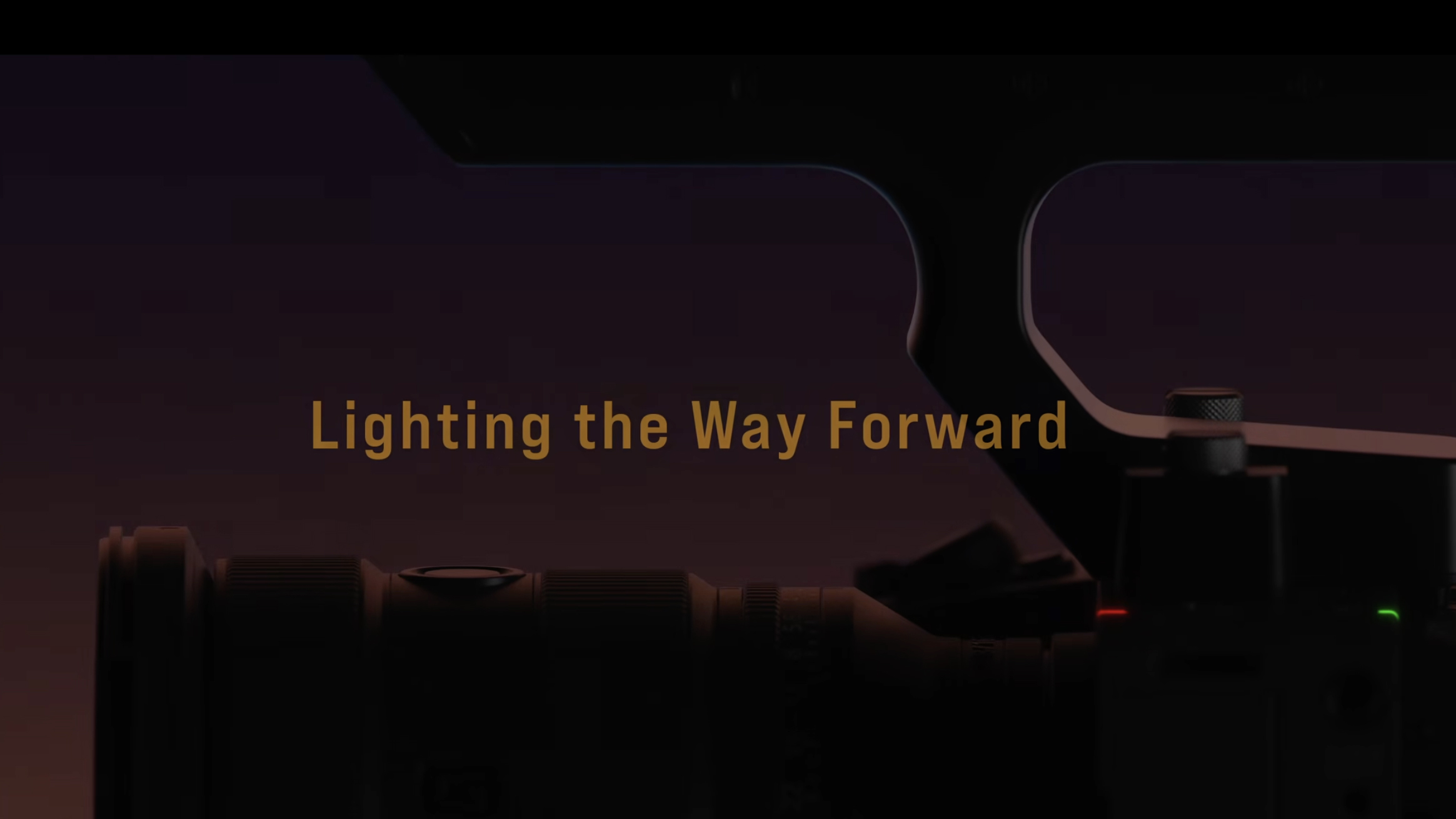 A screenshot of a teaser with the words "lighting the way forward" and a camera in silhouette 