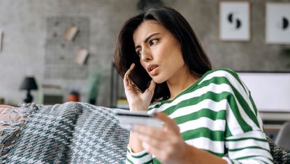 Upset nervous young woman talking on the phone