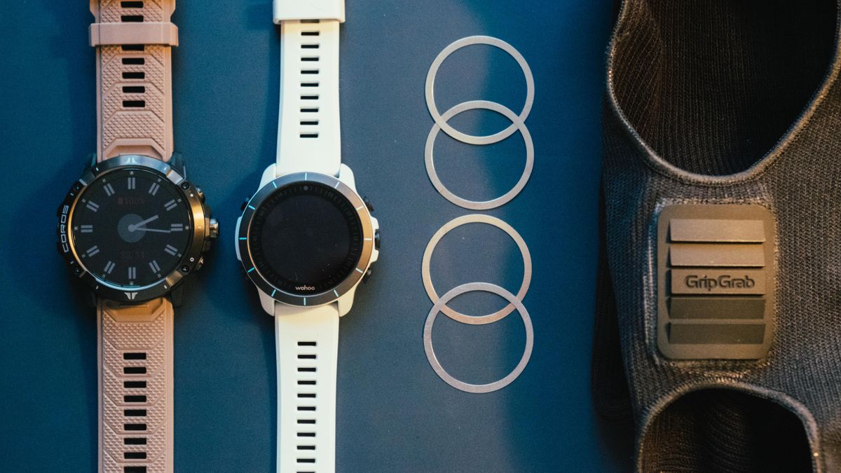 a pair of watches and washers on a blue table