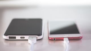 An Apple iPhone charging with a Lightning cable