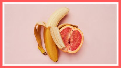 Studio shot of a banana and grapefruit in a suggestive position against a pink background