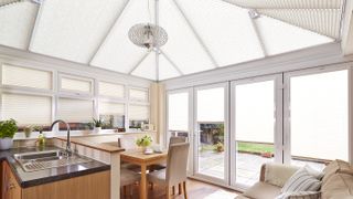 conservatory kitchen with window and roof blinds