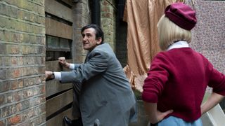 Doctor Turner and Trixie breaking into a boarded up window in Call the Midwife season 14 ep 2