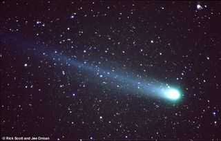 Faint stars near the constellation Ursa Minor (the Little Dipper) shine through Comet Hyakutake's long, graceful tail.