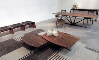 Wooden coffee tables, dining table and bench set on brown and cream geometric rug