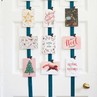 christmas cards displayed with ribbon