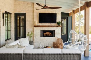 outdoor living room with sofa and swing chairs by LH Designs