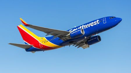 a Southwest jet rockets across the sky