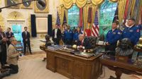 President Donald Trump welcomed the four Artemis 2 astronauts (in blue flight suits) and NASA Administrator Jared Isaacman (in dark suit, in front of American flag) to the Oval Office on April 29, 2026.