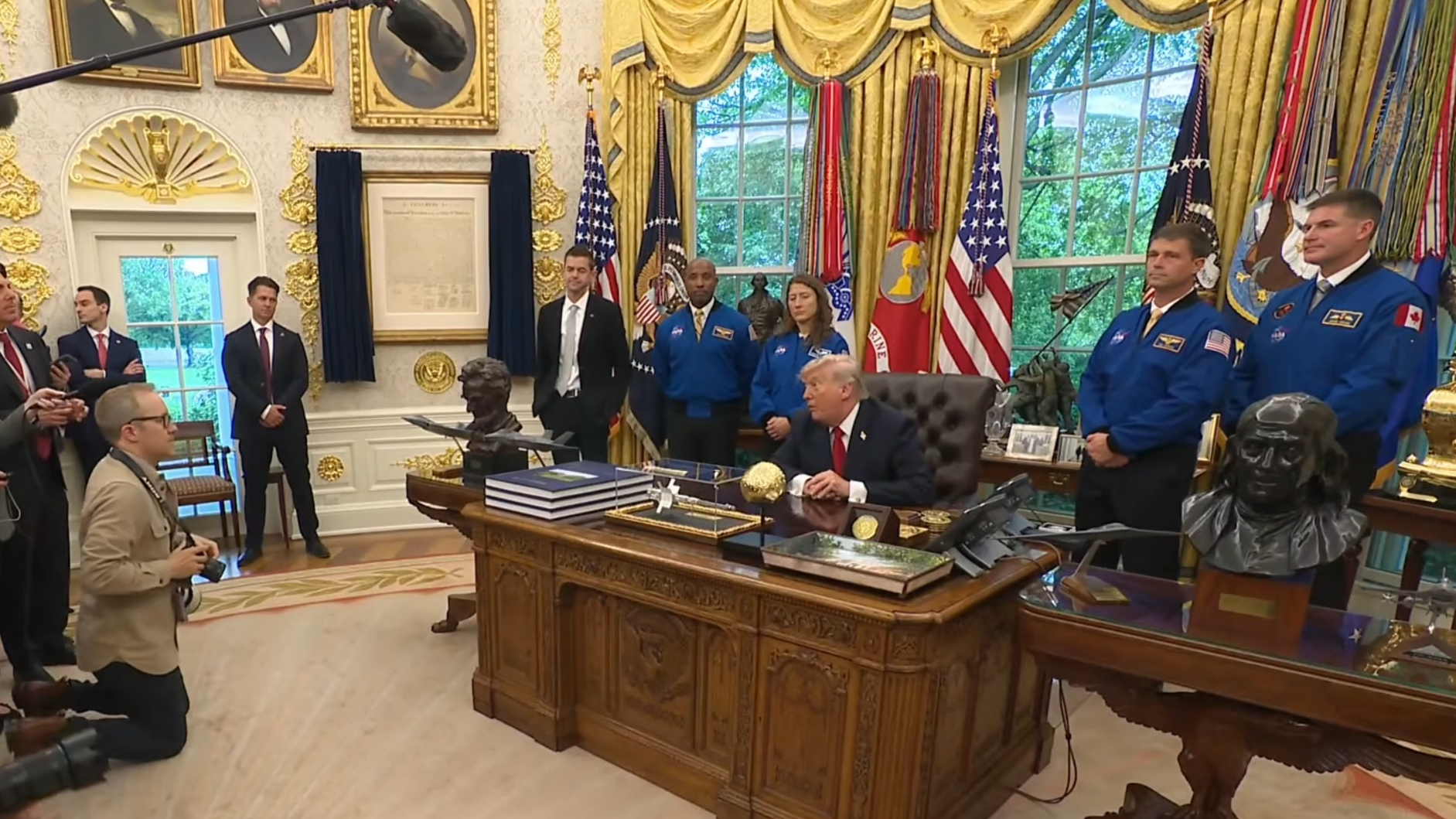 President Donald Trump welcomed the four Artemis 2 astronauts (in blue flight suits) and NASA Administrator Jared Isaacman (in dark suit, in front of American flag) to the Oval Office on April 29, 2026.