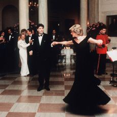 washington, dc november 09 diana, princess of wales, wearing a midnight blue velvet, off the shoulder evening gown designed by victor edelstein, is watched by us president ronald reagan and first lady nancy reagan, as she dances with john travolta at the white house on november 9, 1985 in washington, dc photo by anwar hussein wireimage