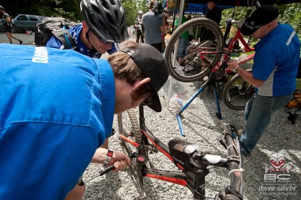 A rider boosts his shock's air pressure.