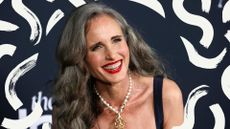 Actor Andie Macdowell, pictured in a black dress with red lipstick after transitioning to gray hair 