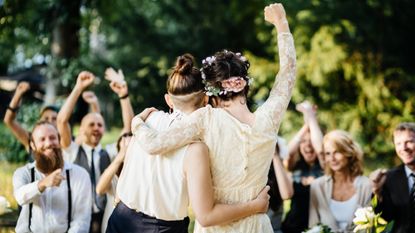 Couple celebrating their marriage in front of their friends at an outdoor wedding