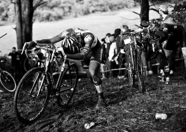 Riders push their bikes up the steep, lengthy run-up