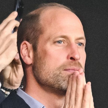 Prince William with his hands on his chin