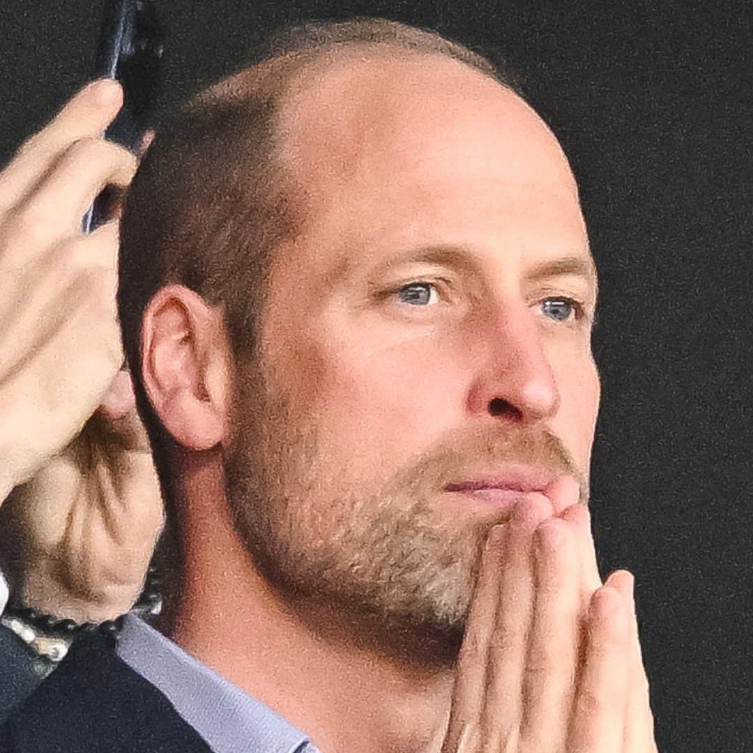 Prince William with his hands on his chin