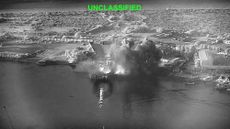 This image from video released by U.S. Central Command shows an explosion at Bandar Abbas Naval Base in Iran, as three Corsair unmanned surface vessels, also called one-way attack surface drones, fired by the U.S. military, hit the port