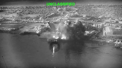 This image from video released by U.S. Central Command shows an explosion at Bandar Abbas Naval Base in Iran, as three Corsair unmanned surface vessels, also called one-way attack surface drones, fired by the U.S. military, hit the port