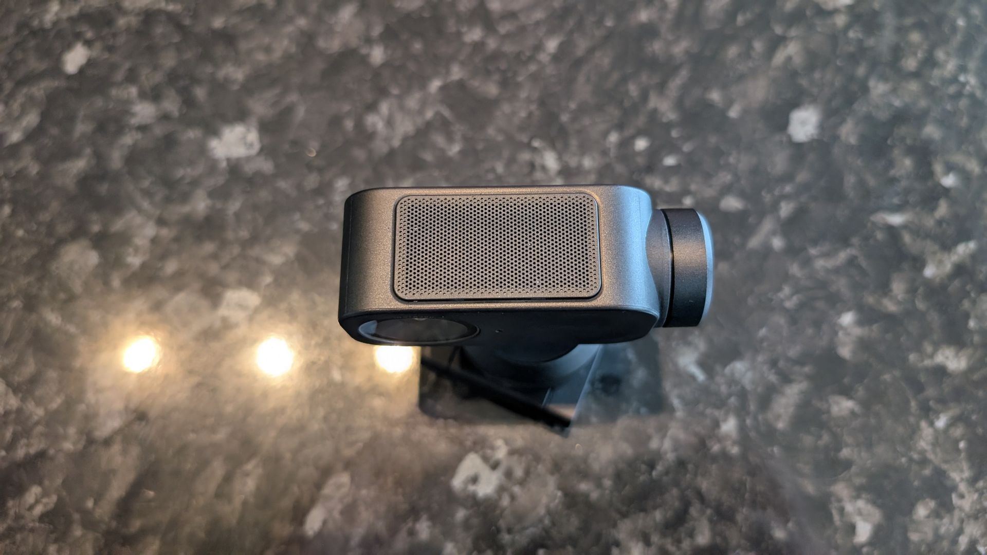 The Insta360 Link 2 Pro webcam, pictured on a marble worktop.