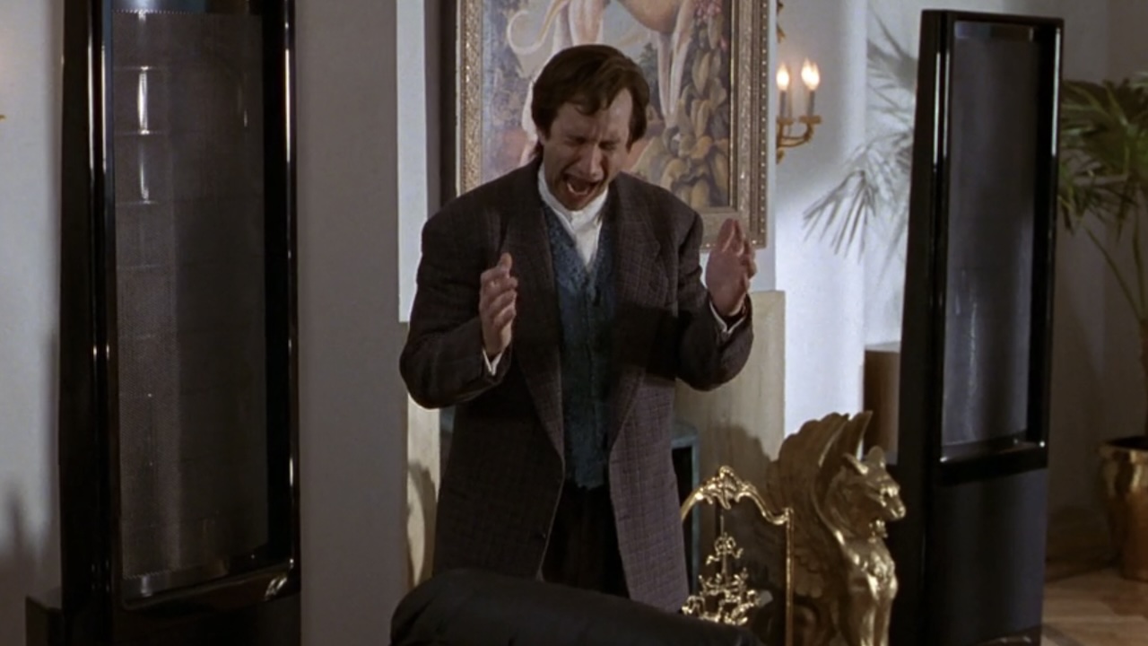 Duarto (Bronson Pinchot) cringing at a chair in The First Wives Club