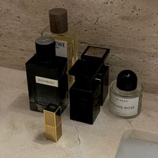 Photo of fragrances sitting on a bathroom sink