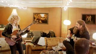 Grace Bowers (left) and Mark Morton (right) playing an electric guitar and an acoustic respectively