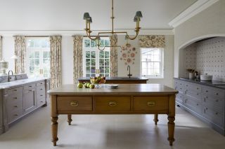 classic French style kitchen with kitchen islands, drapes and blue cabinetry