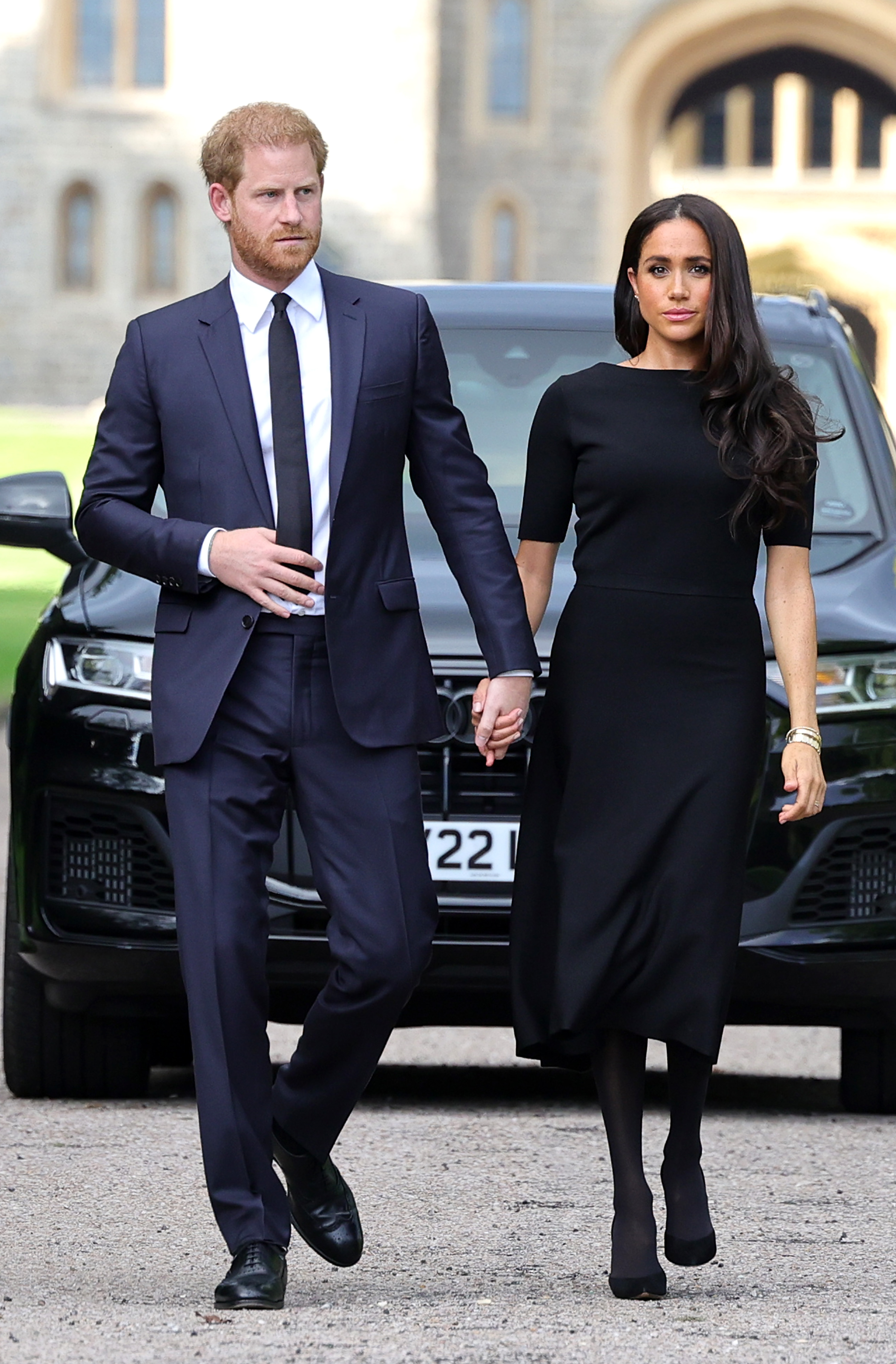 Prince Harry and Meghan Markle wearing black outside Windsor Castle.