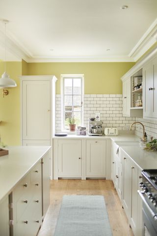 White and yellow kitchen designed by Neptune