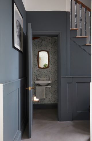 Under stairs cloakroom with floral wallpaper