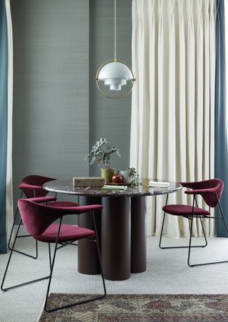 round table in modern dining room with brass pendant by Studio Ashby