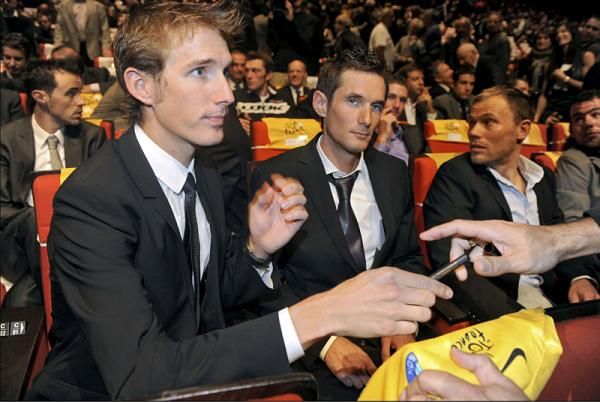Andy Schleck, perhaps prematurely signing a maillot jaune. Alberto Contador has yet to be disqualified from the 2010 race.