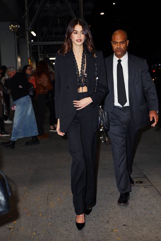 Kaia Gerber attends the 'Saturday Night' screening at The Crosby Hotel in New York wearing a black suit