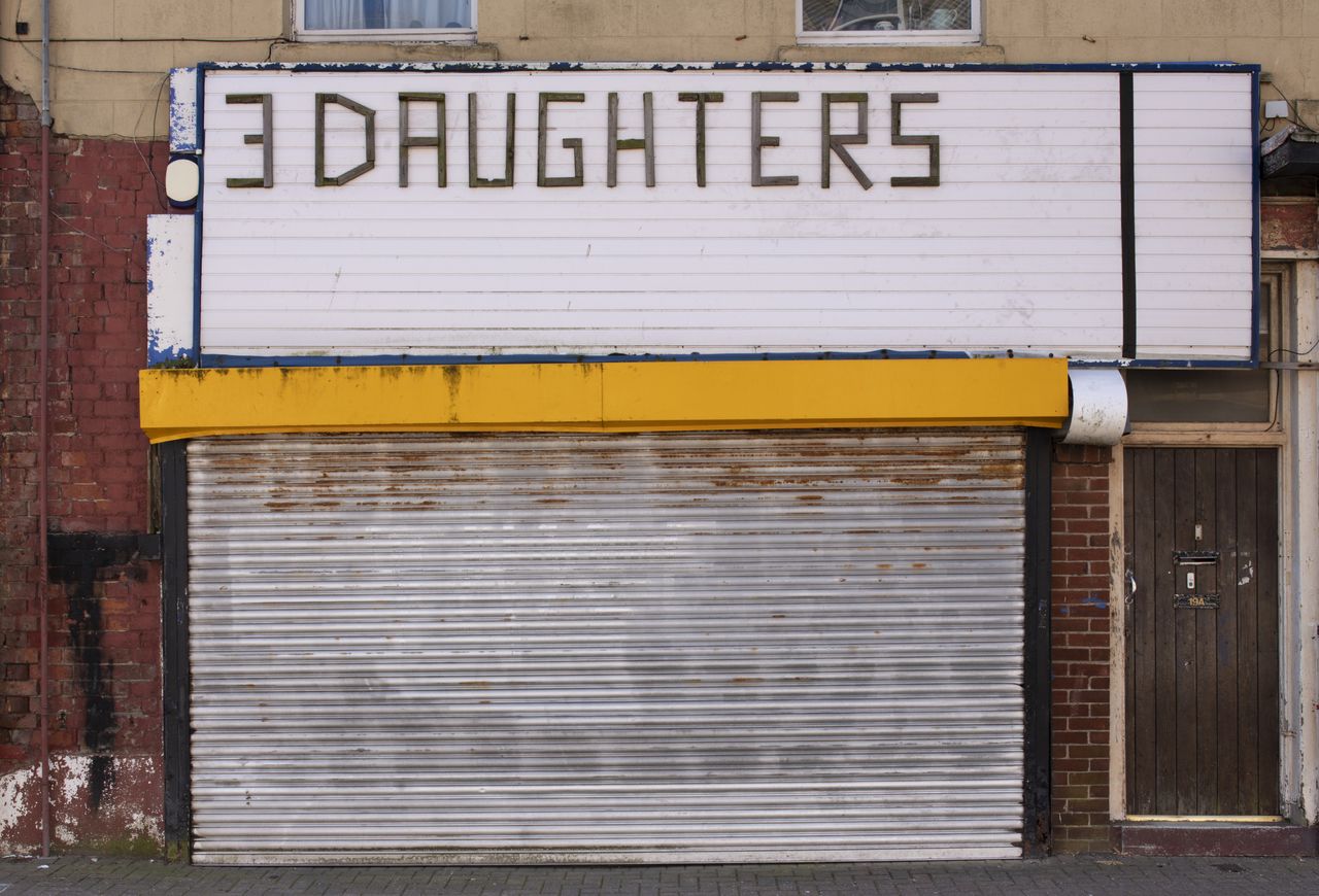 A man stands outside a restored shopfront in Fleetwood