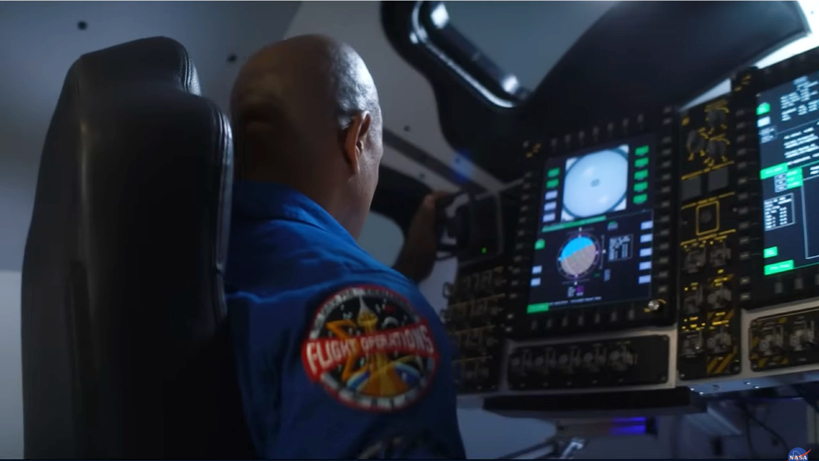 Pilot Victor Glover sat at he controls of an Orion capsule simulator