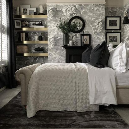 bedroom with grey designed wall bed with white and black pillow and brass shelf