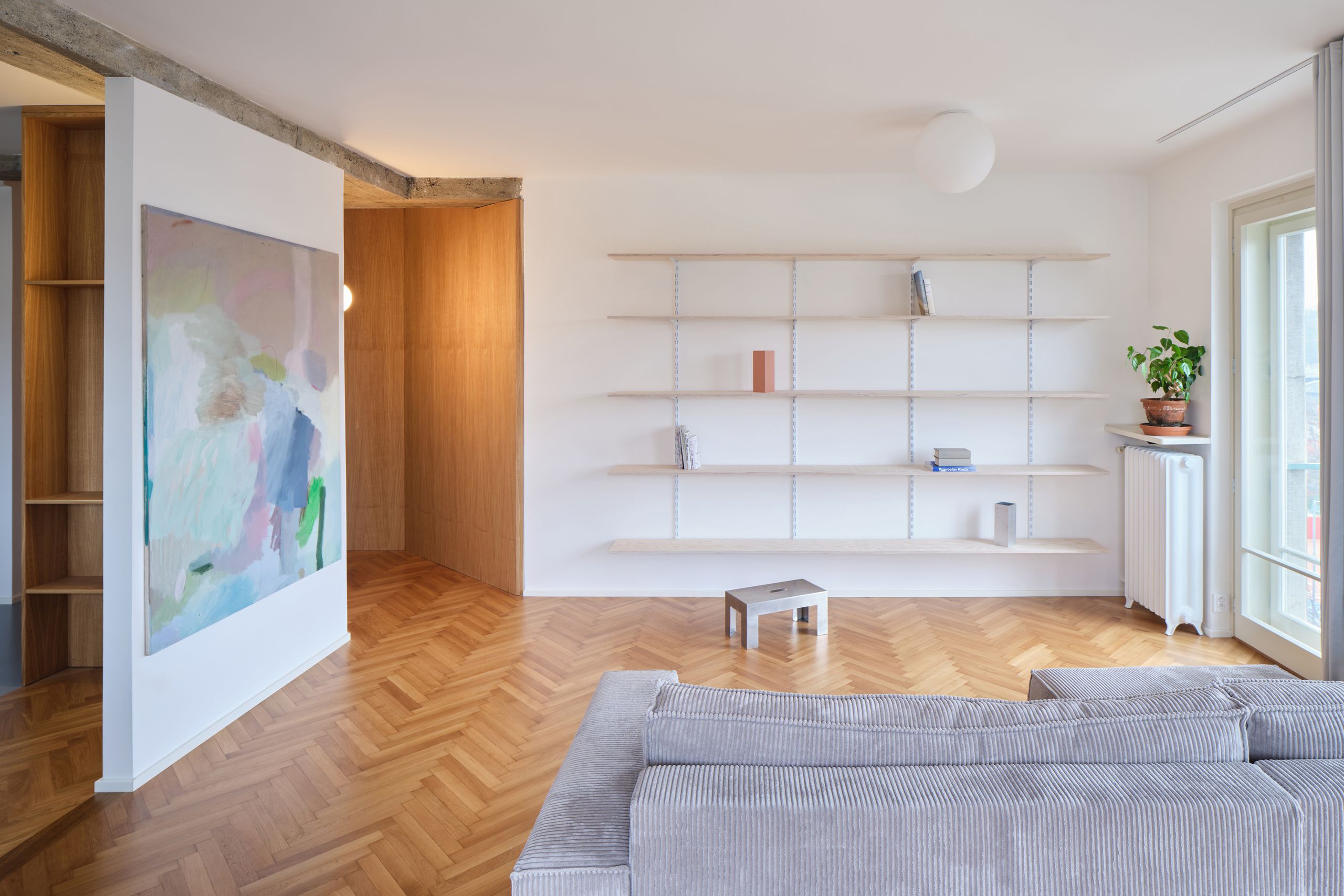 Raw concrete meets candy pastels in this effortlessly cool Prague apartment
