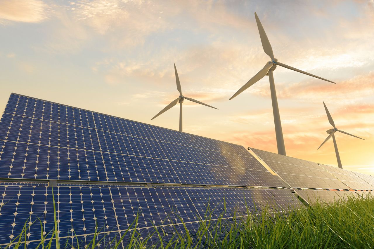 Solar panels and wind turbines under sunlight