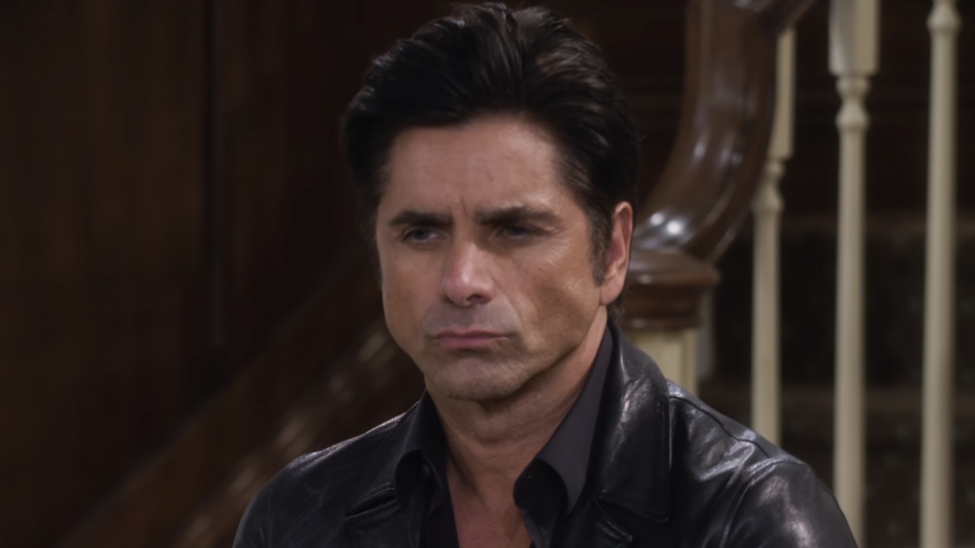 Jesse pursing his lips while talking to the kids in DJ's living room on Fuller House Season 6
