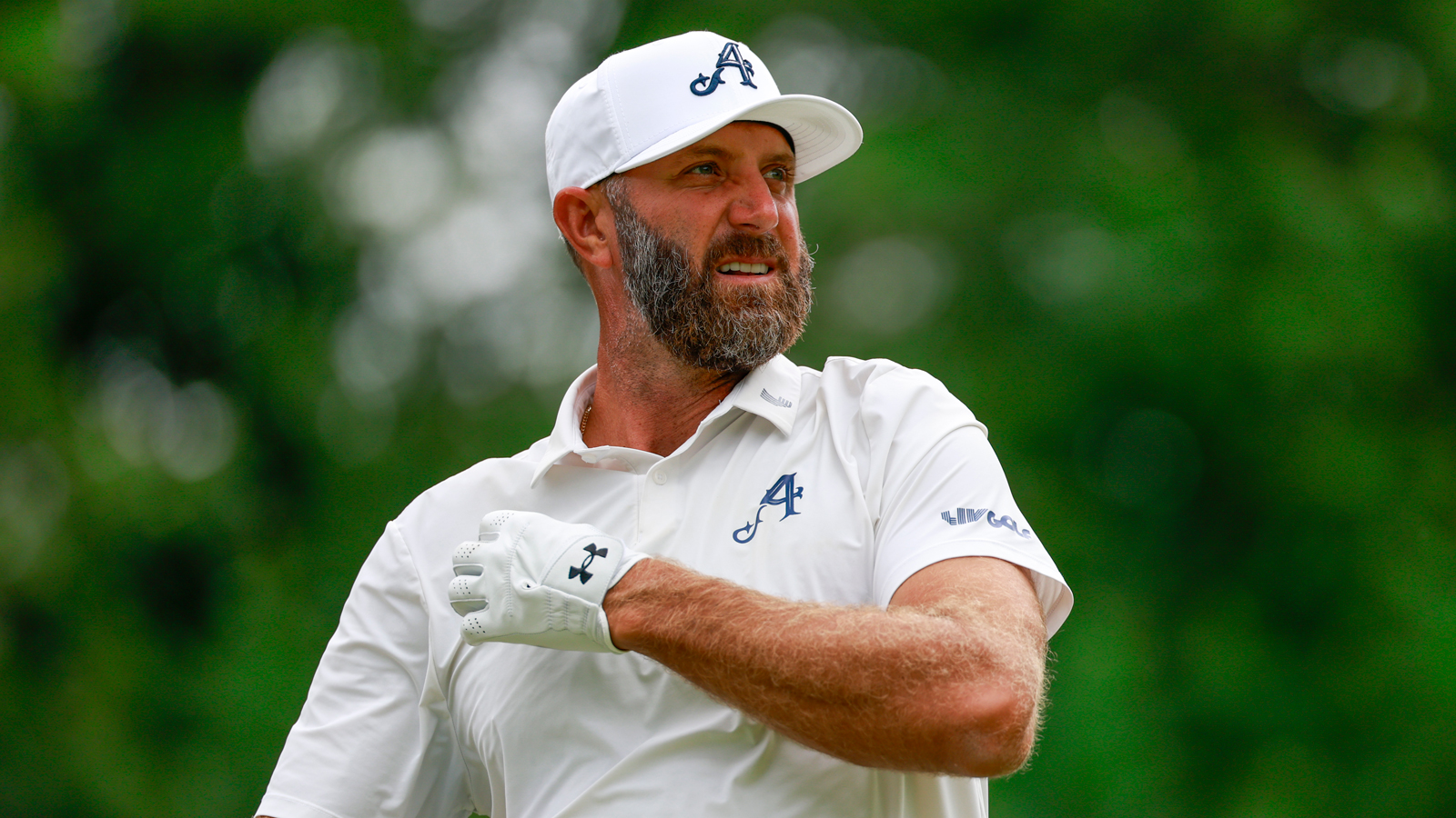 Dustin Johnson watches his tee shot down the fairway