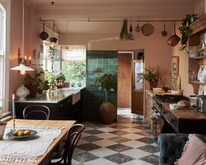 Pink kitchen with tiled floor and green cabinets